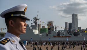 A Chinese sailor stands guard in April at celebrations of the 75th anniversary of the founding of China's navy. Kevin Frayer/Getty Images
