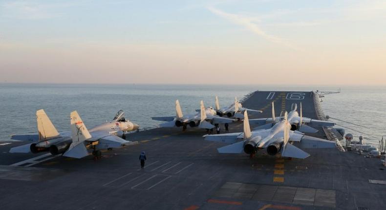 China's Liaoning aircraft carrier on exercise early in December -- the vessel and escorts has sailed south of Taiwan and into the South China Sea