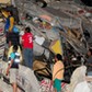 People stand on the debris of a building after an earthquake struck off the Pacific coast in Manta