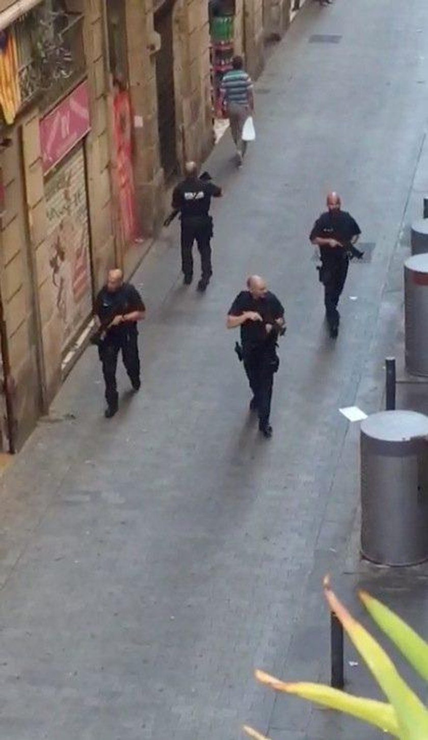 People run away after a van crashed into pedestrians near the Las Ramblas avenue in central Barcelon