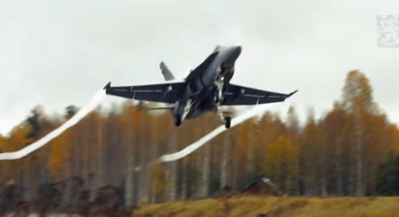 A Finnish F-18 Hornet takes off of a highway.