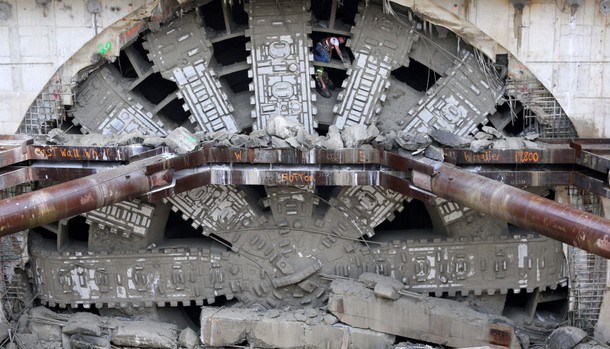 Workers celebrate by posing inside the giant teeth of Seattle?s tunnel-drilling machine, Bertha, the