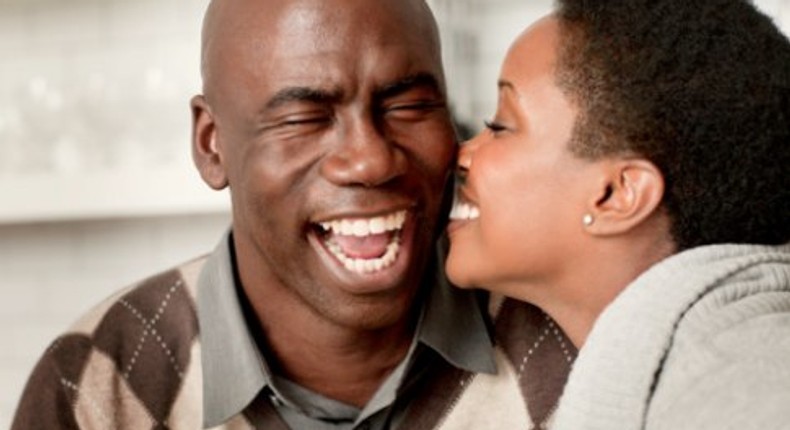 Young lady kissing older man