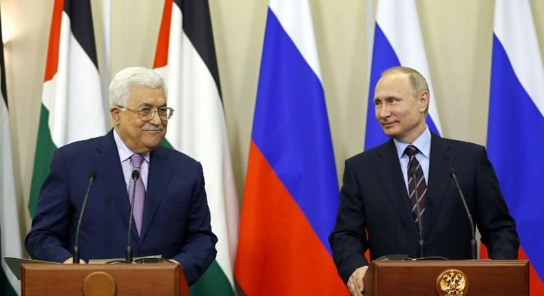 Russian President Vladimir Putin (R) and Palestinian leader Mahmud Abbas take part in a videoconference with Bethlehem following a meeting at the Bocharov Ruchei residence in the Black sea resort of Sochi on May 11, 2017