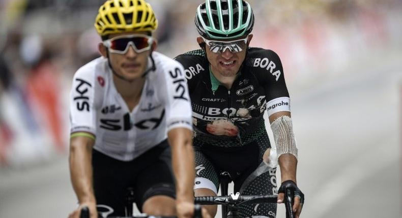 Poland's Michal Kwiatkowski (L) and Poland's Rafal Majka, injured after falling, cross the finish line at the end of the ninth stage of the Tour de France on July 9, 2017