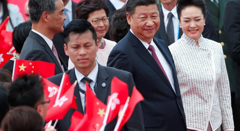 Chinese President Xi Jinping and his wife, Peng Liyuan, arrive at the airport in Hong Kong.