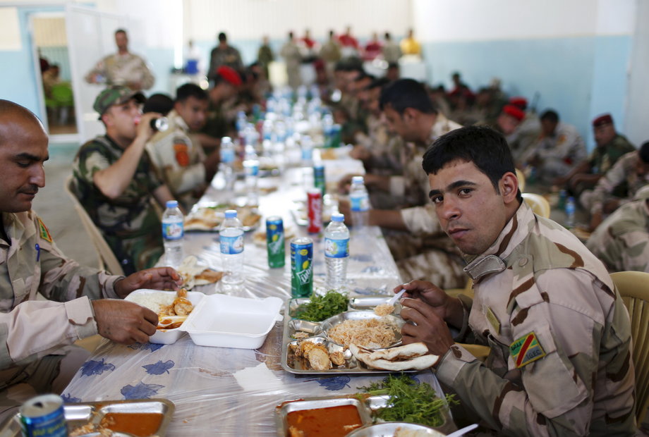 Iraqi soldiers have their lunch at their base in Makhmour, after it was freed from control of Islamic State, south of Mosul.