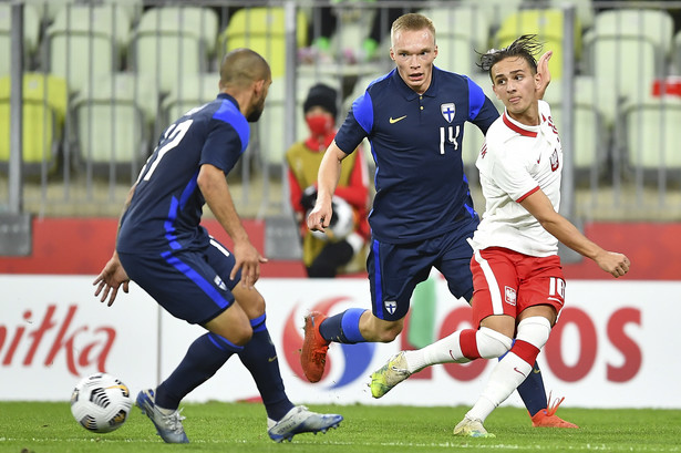 Zawodnik piłkarskiej reprezentacji Polski Michał Karbownik (P) oraz Ilmari Niskanen (C) i Nikolai Alho (L) z Finlandii podczas towarzyskiego meczu na stadionie Energa w Gdańsku