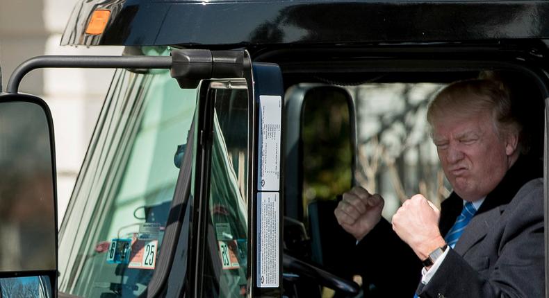 President Donald Trump gestures while sitting in an 18-wheeler truck while meeting with truckers and CEOs regarding healthcare on the South Lawn of the White House in Washington, Thursday, March 23, 2017.