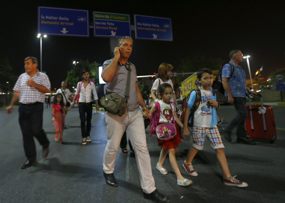 People leave Turkey's largest airport, Istanbul Ataturk, after a blast on June 28.