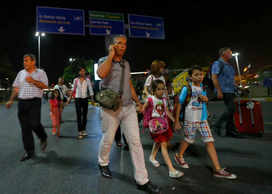 People leave Turkey's largest airport, Istanbul Ataturk, after a blast on June 28.