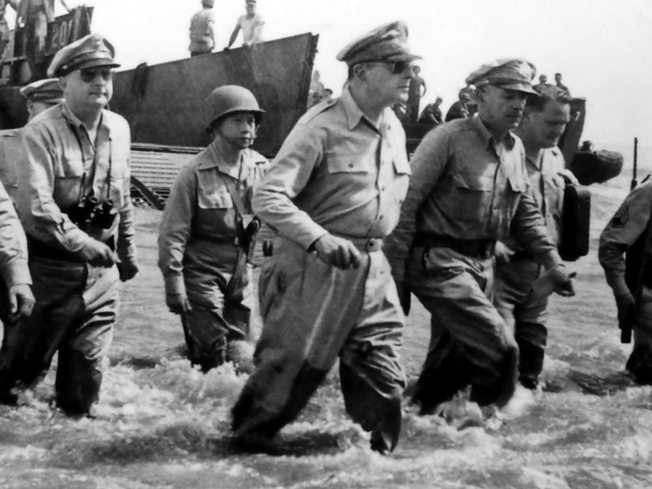 General Douglas MacArthur wades through the water after landing on a beach in the Philippines in 1944.