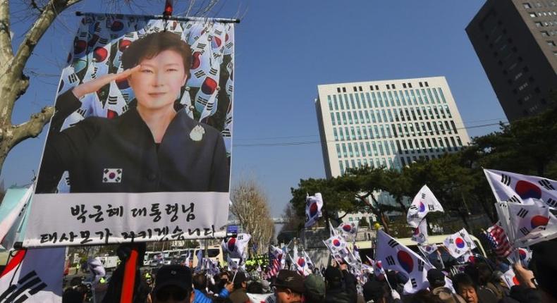 Supporters of South Korea's impeached ex-president Park Geun-Hye rally outside the prosecutors' office in Seoul where she was being questioned on March 21, 2017