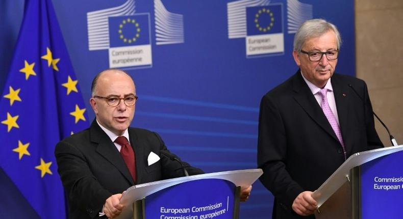 France's Prime Minister Bernard Cazeneuve (L) flanked by European Commission President Jean-Claude Juncker speaks in Brussels on February 6, 2017