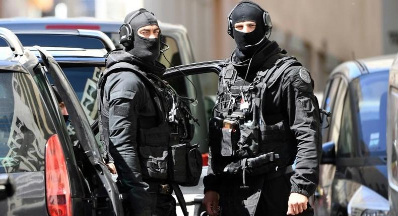 Members of the French RAID police search the home of one of the two men arrested in Marseille on April 18, 2017 in Marseille, on suspicion of planning an imminent attack plot just days from the presidential polls