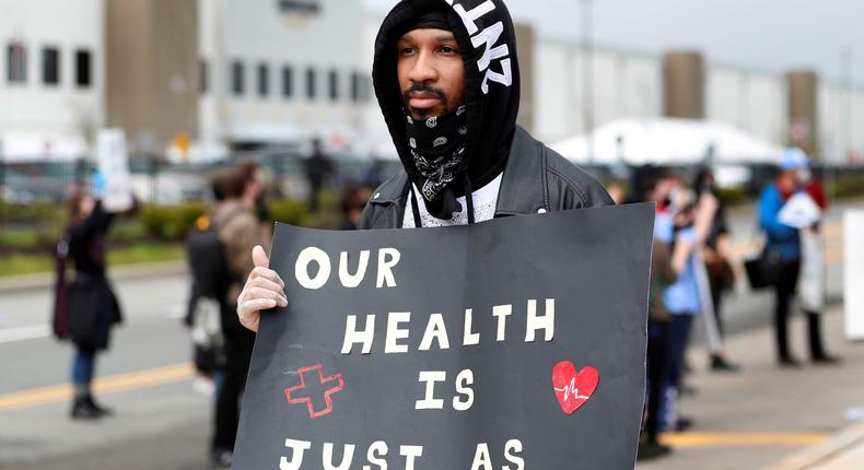 Former Amazon employee, Christian Smalls, stands with fellow demonstrators during a protest outside of an Amazon warehouse in Staten Island on May 1, 2020.
