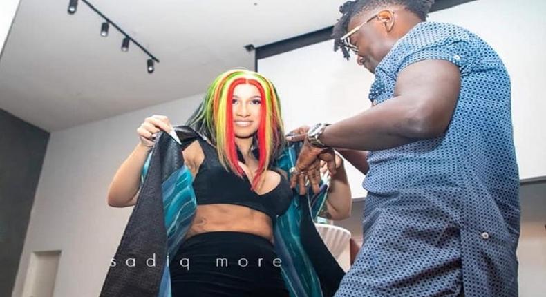 Kwaku Bediako fitting US rapper Cardi B with the jacket Kwaku Bediako gifted her