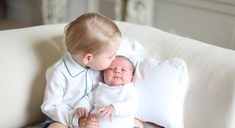 Prince George kisses his sister, Princess Charlotte on her forehead