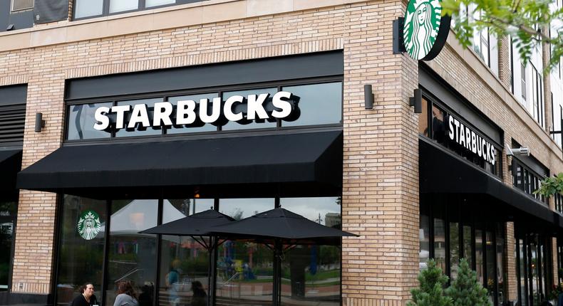 In this July 10, 2019, photo customers visit at a Starbucks in Minneapolis. Starbucks Corp. reports financial earnings on Thursday, July 25, 2019. (AP Photo/Jim Mone)