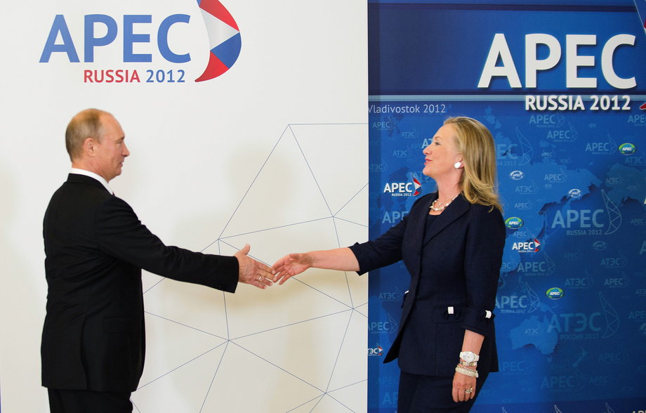 U.S. Secretary of State Hillary Clinton (R) reaches out to shake hands with Russian President Vladimir Putin during the arrival ceremony for the Asia-Pacific Economic Cooperation (APEC) Summit in Vladivostok September 8, 2012.