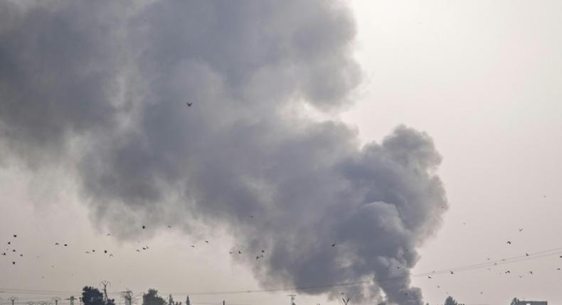 Smoke rises from the Syrian town of Tal Abyad after Turkish bombings Wednesday as Ankara opened up an assault on the mostly Kurdish region