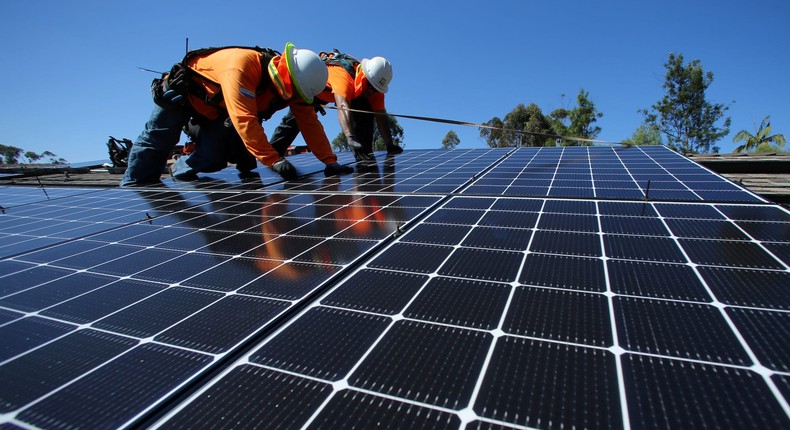 Solar installers from Baker Electric place solar panels on a roof in Scripps Ranch, San Diego.Reuters/Mike Blake