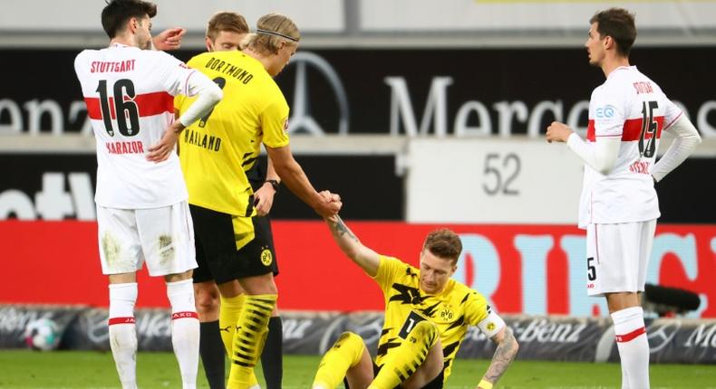 Erling Braut Haaland (2ndl) helps Dortmund captain Marco Reus (C) in the 3-2 win at Stuttgart on Saturday