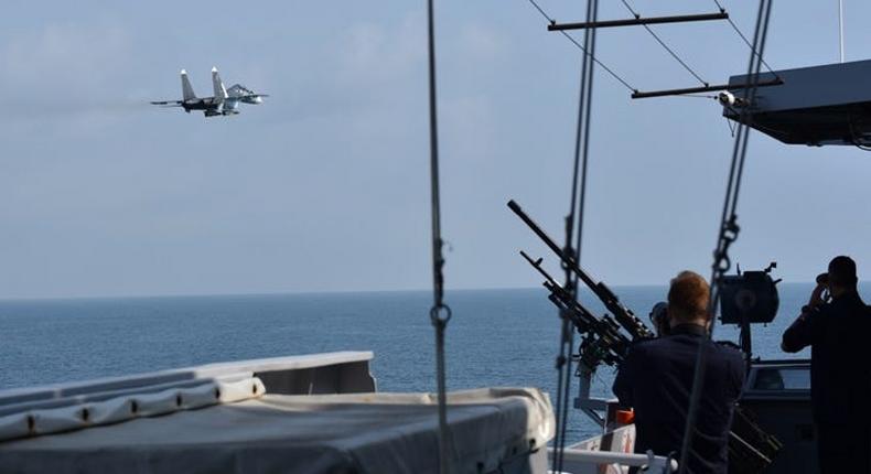 A Russian fighter jet flying past the Royal Netherlands Navy frigate HNLMS Eversten in the Black Sea
