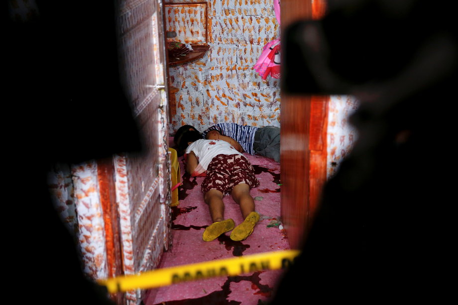 The bodies of two of four people killed in a drugs buy-bust operation are seen inside a house in Manila, Philippines, early on October 25, 2016.
