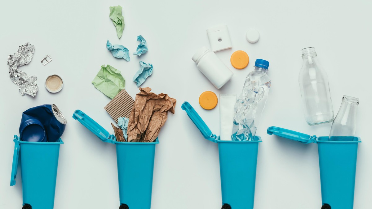 top view of trash bins and assorted garbage isolated on grey, recycle concept