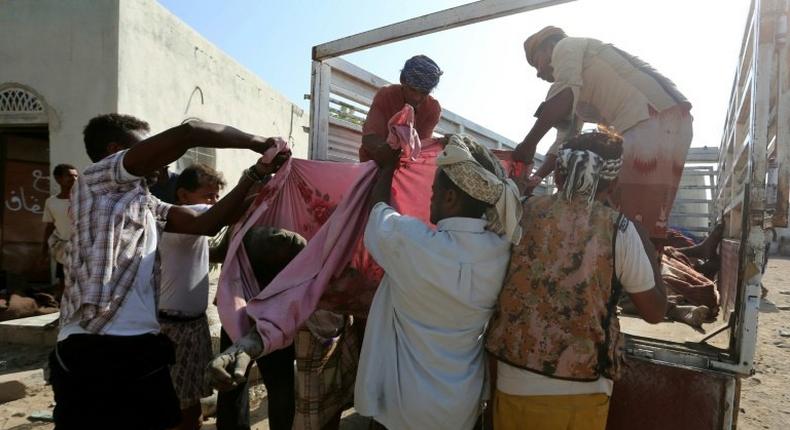 Yemenis recover the bodies of people at a detention centre hit by Saudi-led coalition air strikes in Hodeidah, on October 30, 2016