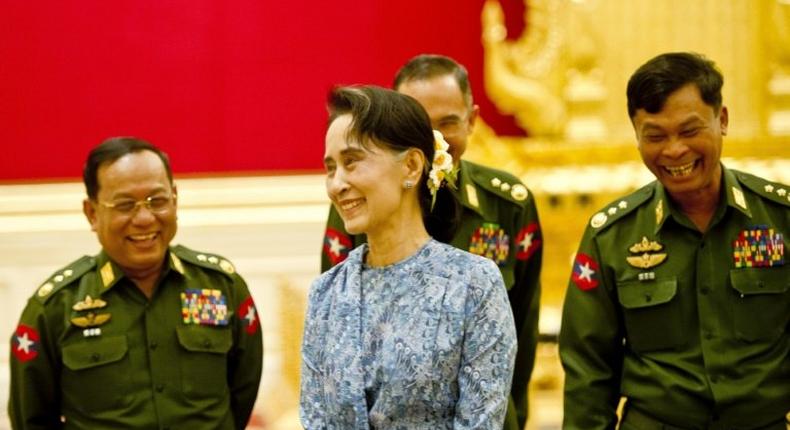 De facto leader Aung San Suu Kyi (C) faces dissent over the role of Myanmar's still powerful military, especially a bloody crackdown on Rohingya Muslims