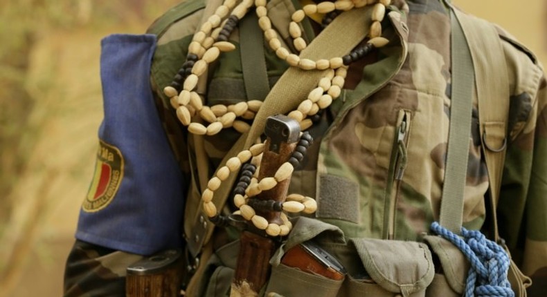 A Malian soldier guards a checkpoint on the road between Gao and Kidal