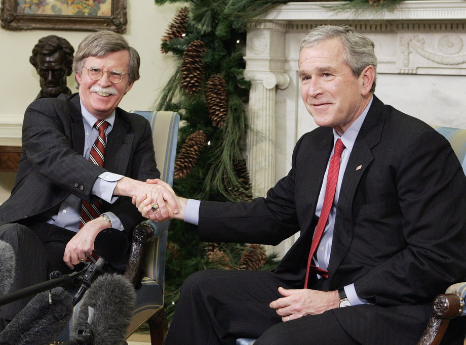 President George W. Bush shakes hands with the UN representative John Bolton.