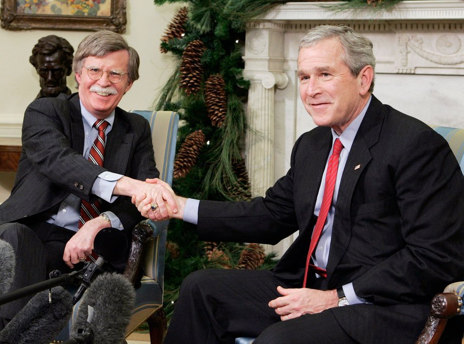 President George W. Bush shakes hands with the UN representative John Bolton.