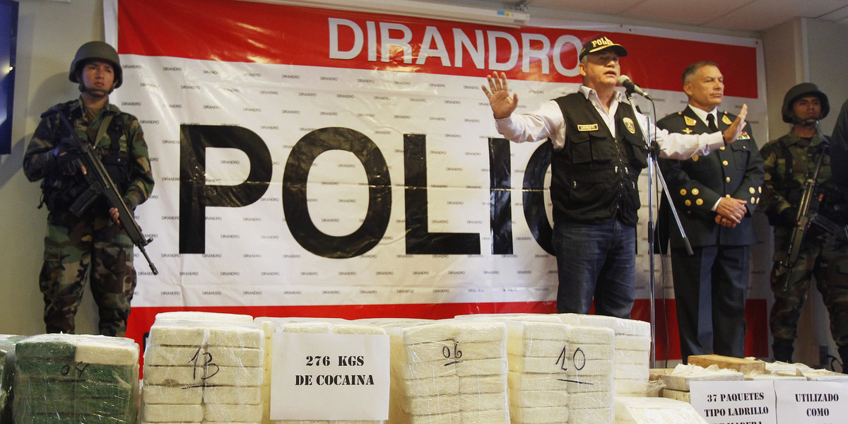 Peru's Interior Minister Daniel Urresti speaks to media next to seized cocaine bricks at a police headquarters in Lima, November 4, 2014.