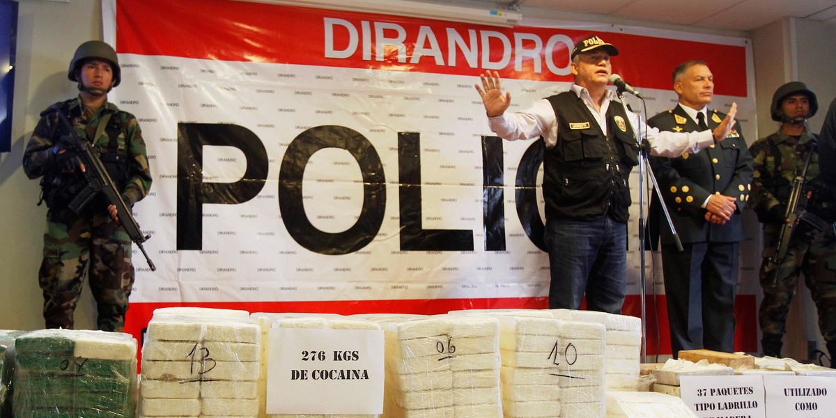 Peru's Interior Minister Daniel Urresti speaks to media next to seized cocaine bricks at a police headquarters in Lima, November 4, 2014.