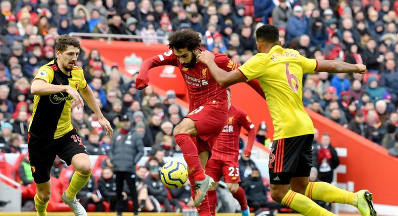 Liverpool star Mohamed Salah (C) shoots as two Watford defenders close in during a Premier League  match at the weekend Creator: Paul ELLIS