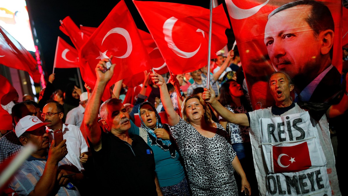 People shout slogans and wave Turkish national flags as they have gathered in solidarity night after