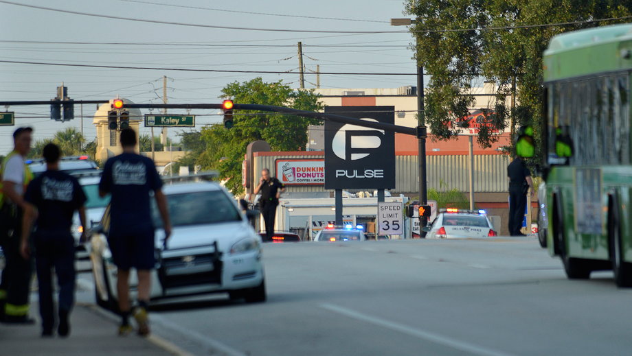 Police officers locked down Orange Avenue on Sunday around the Pulse nightclub, where people were killed by a gunman in a shooting rampage in Orlando, Florida.