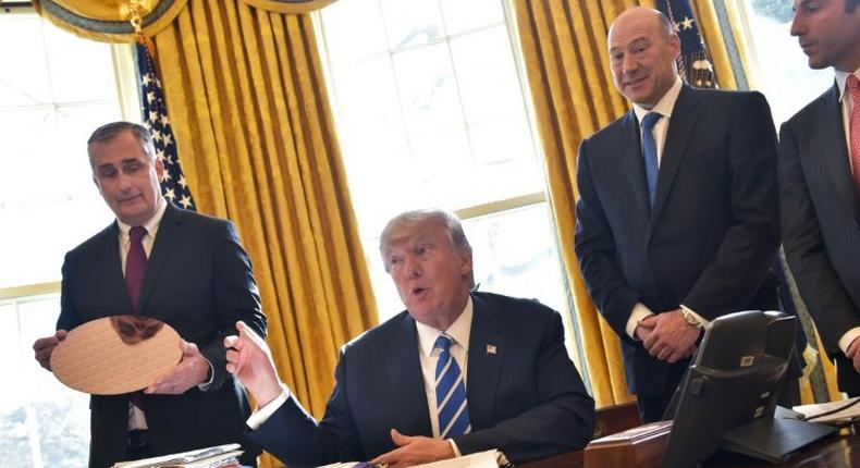 In February, US President Donald Trump (2nd L) and Intel CEO Brian Krzanich (L) met in the Oval Office -- this week, Krzanich left his advisory panel on manufacturing