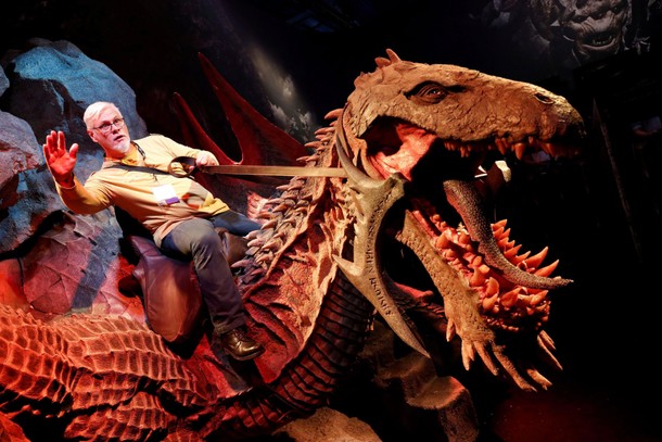 A man rides a model of a dragon during the opening of the world's largest computer games fair Gamesc