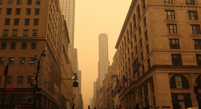 People cross 5th Avenue as heavy smoke fills the air on June 7, 2023, in New York City.Gary Hershorn/Getty Images