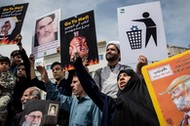 Iranians shout slogans during a protest against President Donald Trump's decision to walk out of a 2