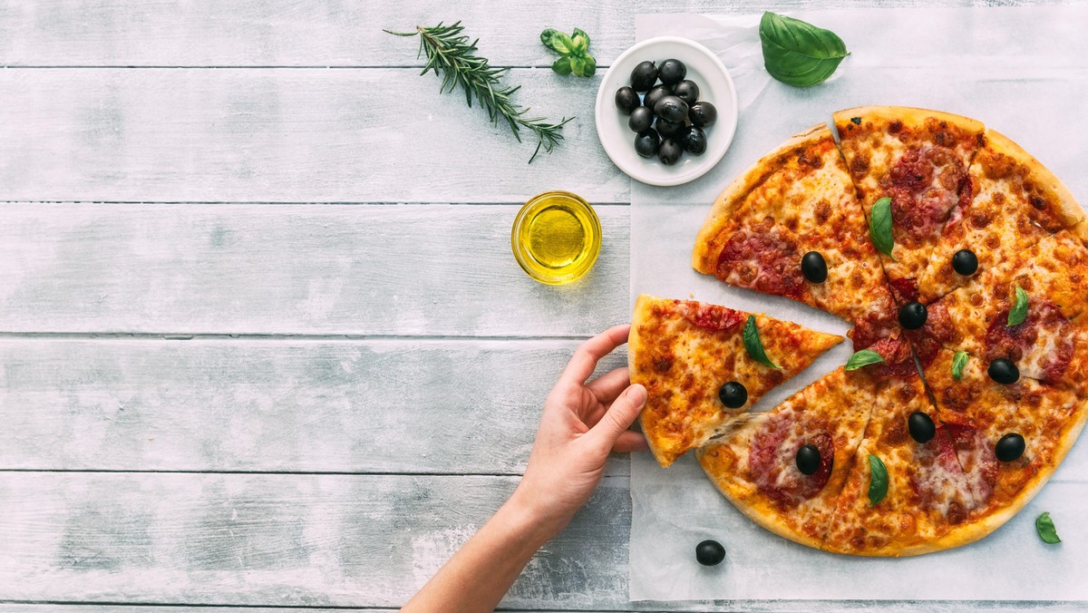 colorful tasty pizza. woman taking piece of italian pizza