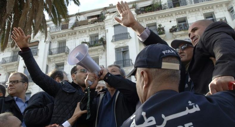 Algerian trade unionists gather outside the People's National Assembly bulding in the capital Algiers on November 27, 2016, to protest a draft law on pension reforms