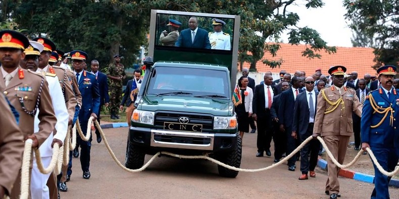 President Uhuru Kenyatta is pulled by high-ranking military officers from the Department Of Defence HQ in Nairobi on September 9, 2022