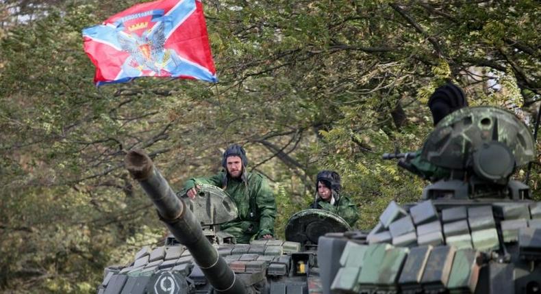 Pro-Russian separatists soldiers withdraw their tanks from position near town of Novoazovsk in Donetsk region on October 21, 2015