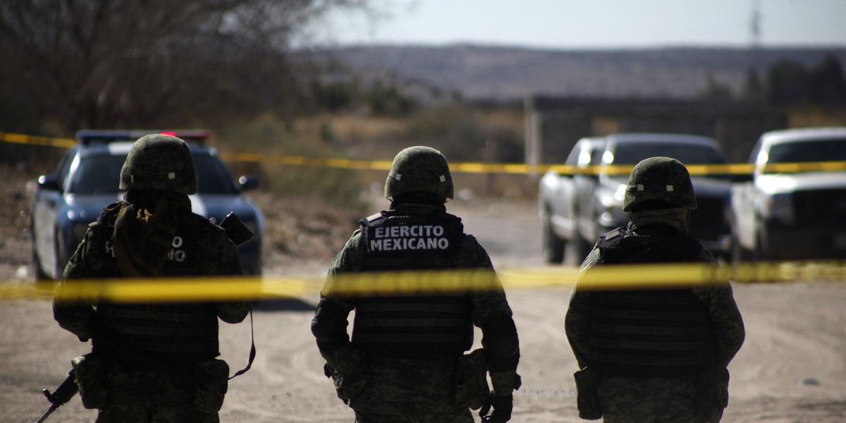 Soldiers stand at the site of a gun battle in the Valley of Juarez, on the outskirts of Ciudad Juarez, on February 17, 2015.