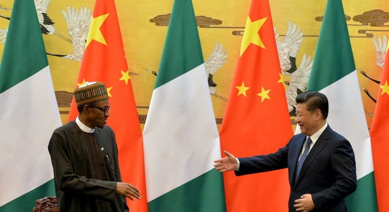 President of the Federal Republic of Nigeria, Muhammadu Buhari (L) and Chinese President, Xi Jinping shake hands during a signing ceremony at the Great Hall of the People in Beijing, April 12, 2016. REUTERS/Kenzaburo Fukuhara/Pool